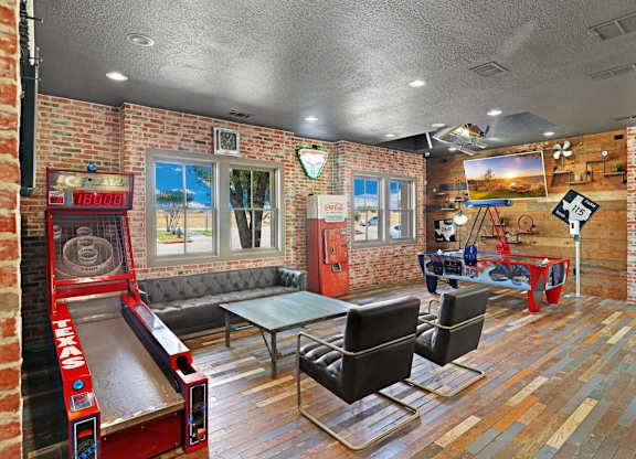A room with a bowling alley and a pool table.