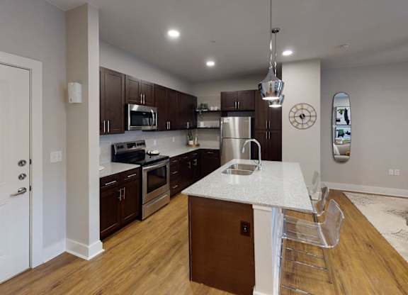 a kitchen with a marble counter top at The Fitzroy San Marcos, San Marcos