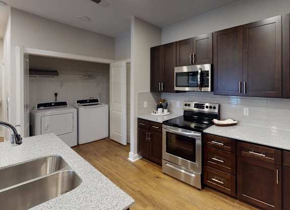 a kitchen with a stove and a sink at The Fitzroy San Marcos, San Marcos