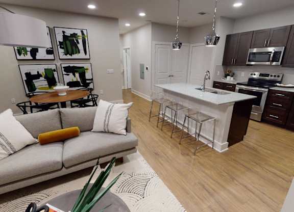 a living room with a kitchen and a couch at The Fitzroy San Marcos, San Marcos
