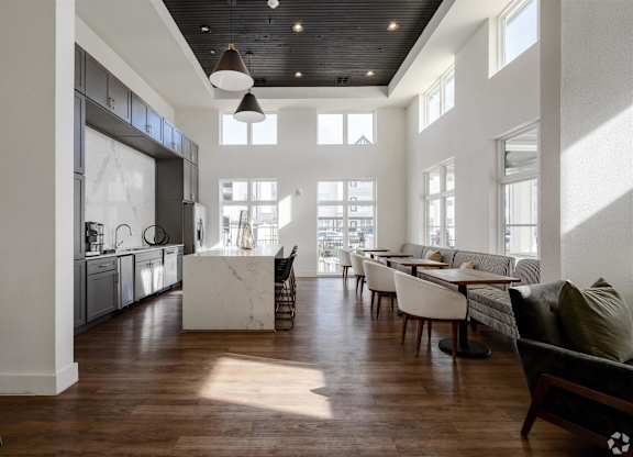 a large living room with a kitchen and a dining room at The Fitzroy San Marcos, San Marcos, TX