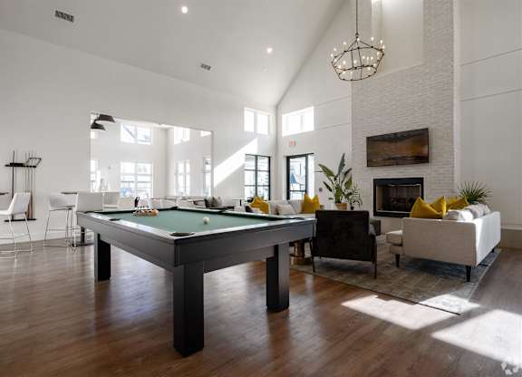 an open living room with a pool table at The Fitzroy San Marcos, San Marcos