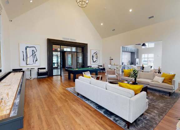 a living room with a couch and a pool table at The Fitzroy San Marcos, San Marcos, TX