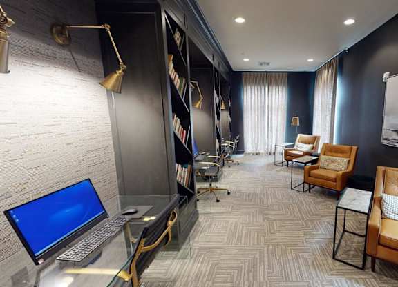 a conference room with a laptop computer on a desk at The Fitzroy San Marcos, San Marcos, Texas