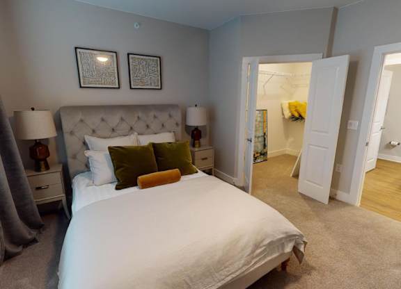 a bedroom with a large bed and a closet at The Fitzroy San Marcos, San Marcos, Texas