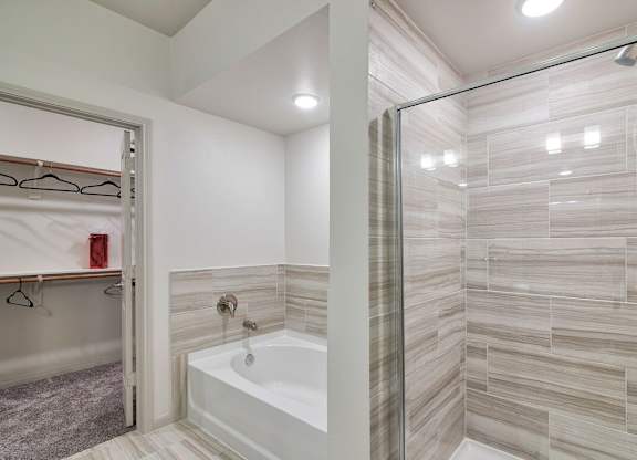 Walk-In Showers With Built-In Bench And Glass Enclosure at Seville at Clay Crossing, Texas