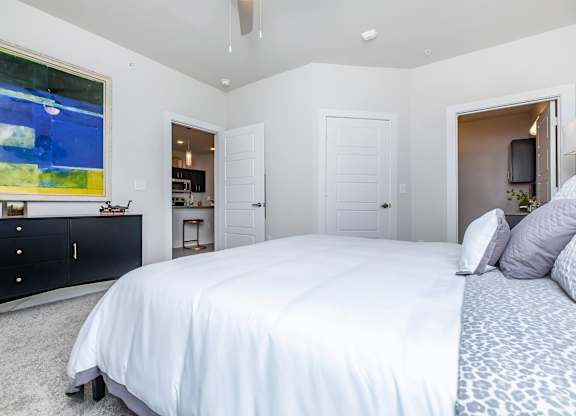 Spacious bedroom with vaulted ceiling and ensuite access at Sienna at Westover Hills Apartments, San Antonio, Texas