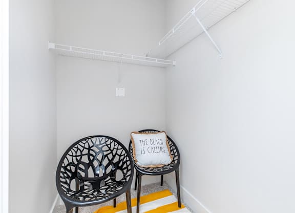 Walk-in closet with wire shelving and chairs at Sienna at Westover Hills Apartments, Texas, 78253