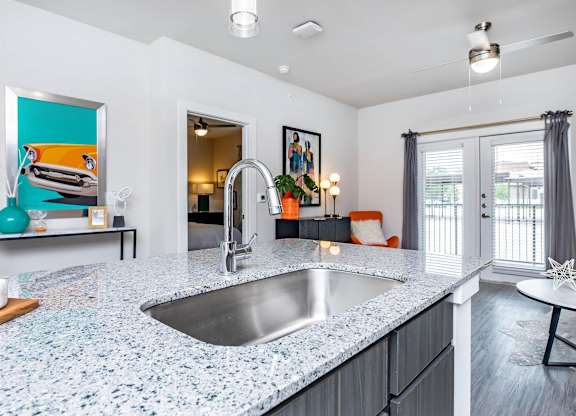 Kitchen island with granite countertop and bar seating at Sienna at Westover Hills Apartments, San Antonio, TX
