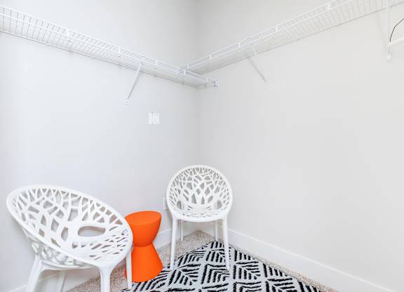 Walk-in closet seating area with modern chairs at Sienna at Westover Hills Apartments, Texas