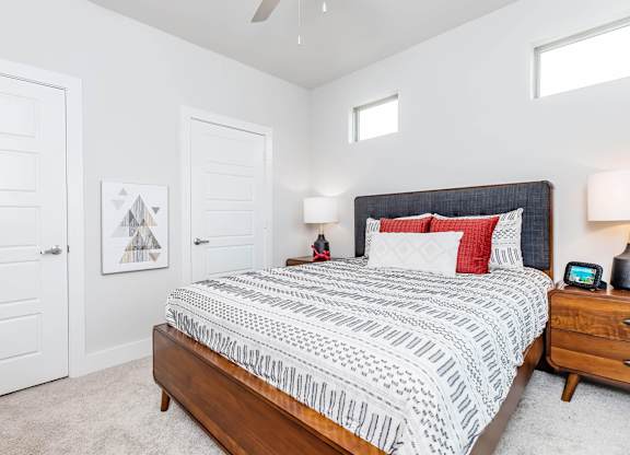 Bedroom with upholstered headboard and geometric patterned bedding at Sienna at Westover Hills Apartments, San Antonio, TX