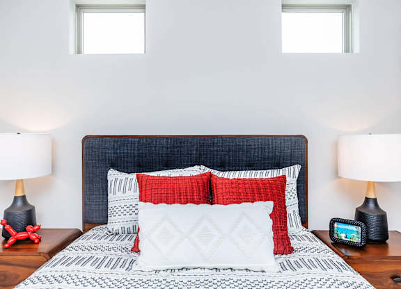 Bedroom with textured headboard and coordinating bedding at Sienna at Westover Hills Apartments, San Antonio, Texas