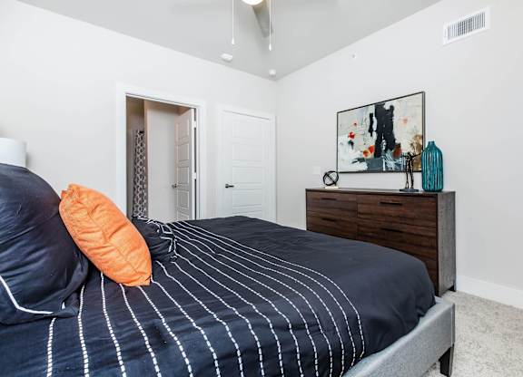 Bedroom with dresser and abstract wall art at Sienna at Westover Hills Apartments, San Antonio, 78253