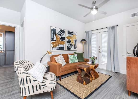 Living room with sculptural coffee table and floor lamp at Sienna at Westover Hills Apartments, Texas, 78253