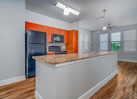 Kitchen with black appliances at The Landings at Brooks City-Base, San Antonio