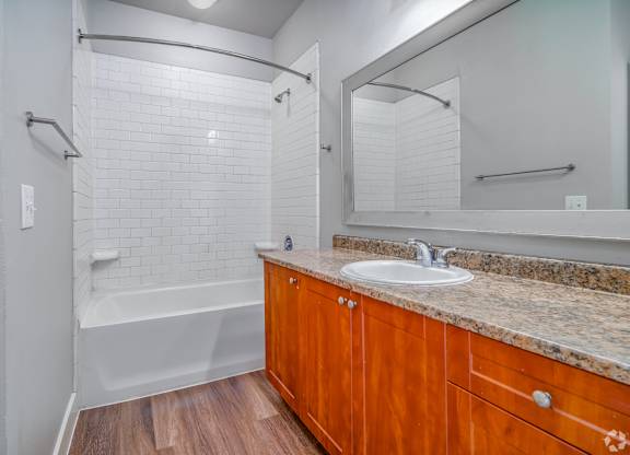 Bathroom with white tub at The Landings at Brooks City-Base, San Antonio, Texas