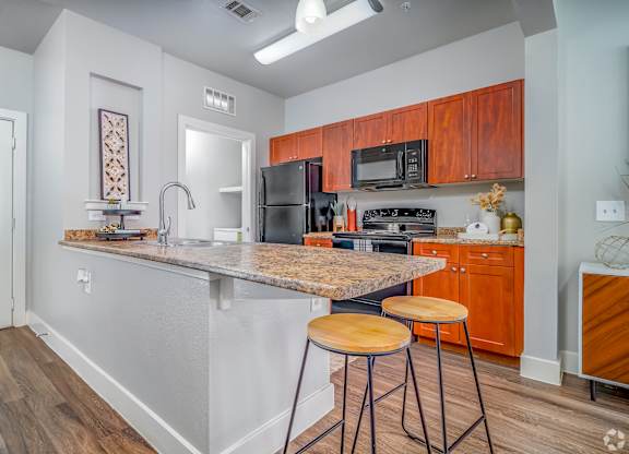 Kitchen with granite countertop at The Landings at Brooks City-Base, Texas