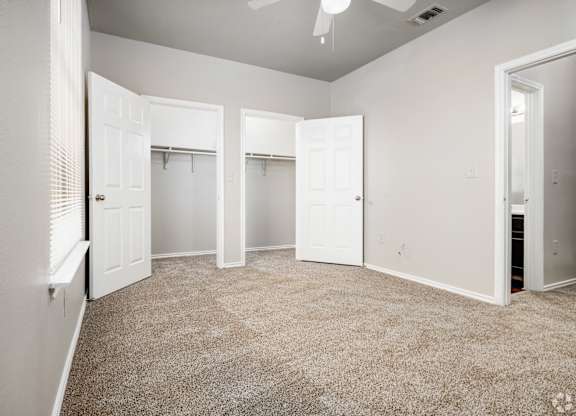 Spacious bedroom with dual walk-in closets at Houston Street Townhomes Apartments, San Antonio, 78220