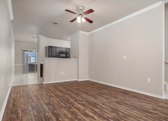 Open living area with wood style flooring at Houston Street Townhomes Apartments, Texas