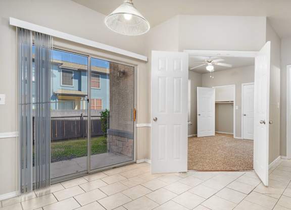 Entryway with tile flooring and patio access at Houston Street Townhomes Apartments, San Antonio