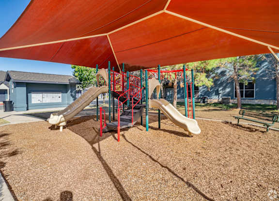 Playground with shade canopy and slides at Houston Street Townhomes Apartments, San Antonio