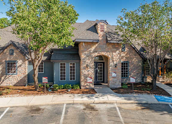 Stone and brick townhome exterior with archway entrance at Houston Street Townhomes Apartments, San Antonio, TX 78220
