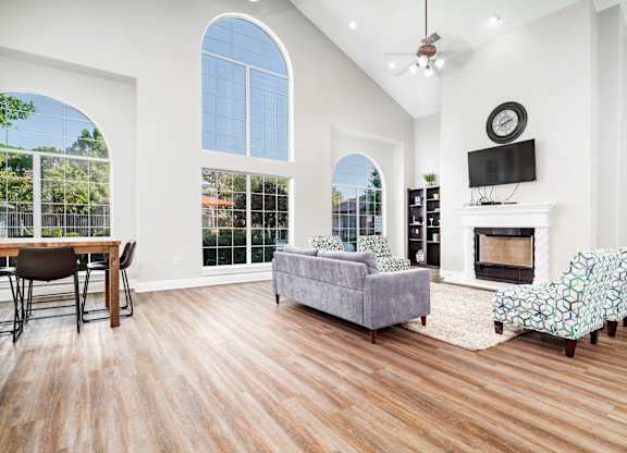Living room with vaulted ceiling and fireplace at Houston Street Townhomes Apartments, San Antonio, TX