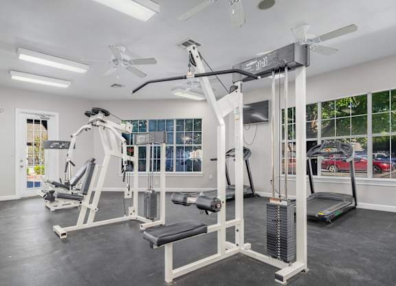 Fitness center with weight machines and cardio equipment at Houston Street Townhomes Apartments, San Antonio, 78220