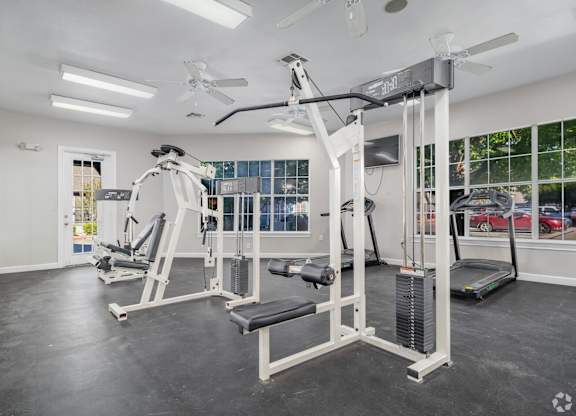 Fitness center with weight machines and cardio equipment at Houston Street Townhomes Apartments, San Antonio, Texas