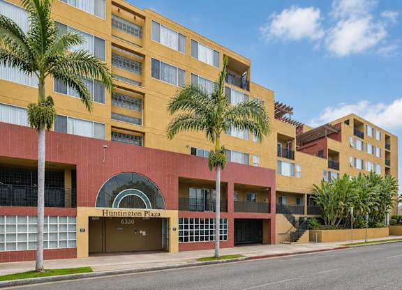 Huntington Plaza is a multi-story building with a red and yellow facade.