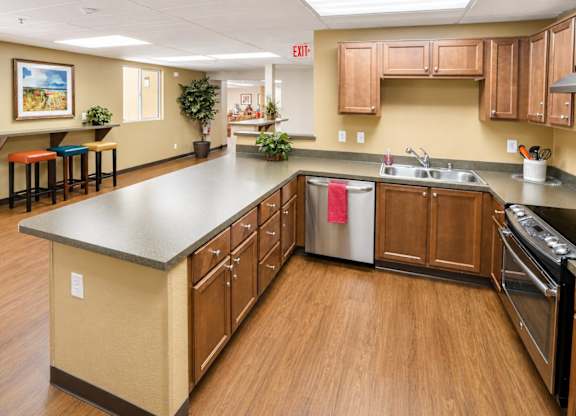A kitchen with wooden cabinets and a large island.