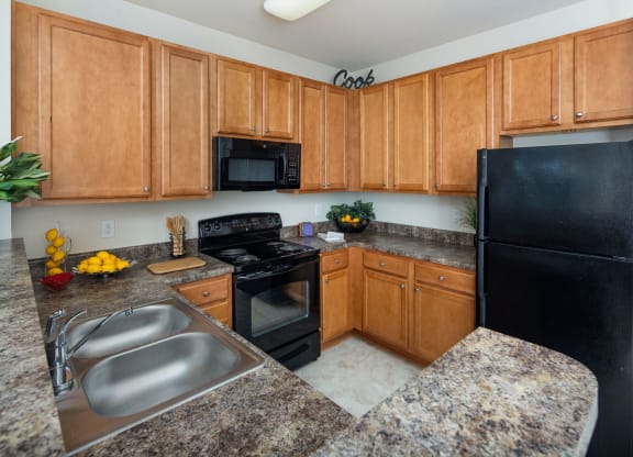 Kitchen With Sink, Refrigerator And Modern Appliances at Abberly Village Apartment Homes by HHHunt, South Carolina, 29169