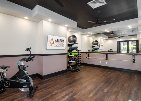 a gym with exercise equipment and a counter with a sink at Abberly Foundry Apartment Homes, Nashville, 37203
