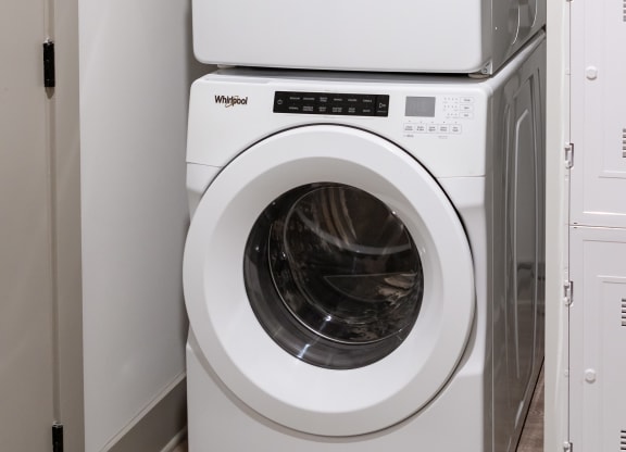 a washer and dryer sit next to each other in a laundry room at Abberly Foundry Apartment Homes, Nashville, 37203