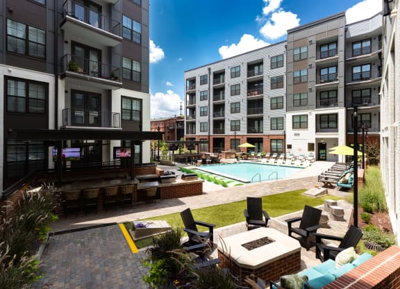 an outdoor lounge area with lounge chairs and a fire pit at the bradley braddock  at Abberly Foundry Apartment Homes, Nashville