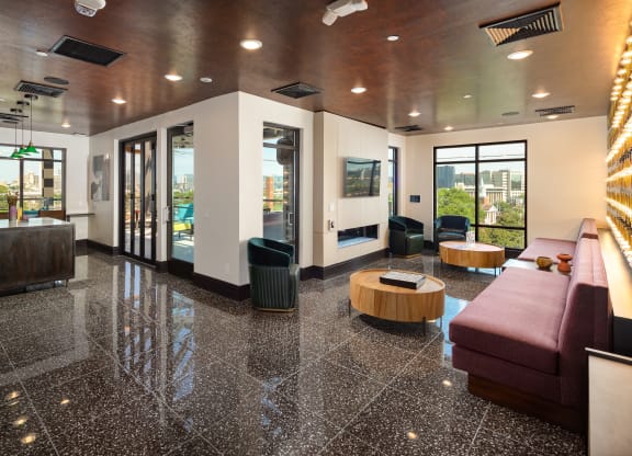 a view of the lobby of the building with a red couch and black and white tile floor at Abberly Foundry Apartment Homes, Nashville