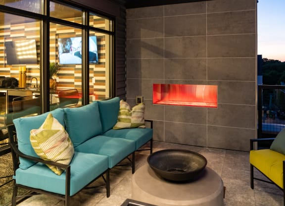 a living room with a blue couch and yellow chairs at Abberly Foundry Apartment Homes, Nashville, TN