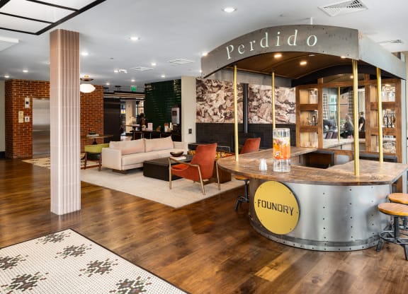 a reception area with a reception desk and couches at Abberly Foundry Apartment Homes, Nashville, TN, 37206