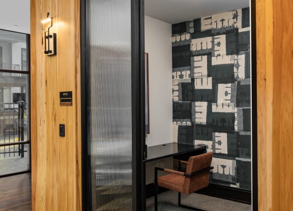 a meeting room with a wooden wall and a glass door at Abberly Foundry Apartment Homes, Nashville, TN, 37206