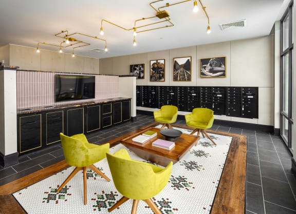 a living room filled with yellow chairs and a wooden tableat Abberly Foundry Apartment Homes, Nashville, TN, 37206