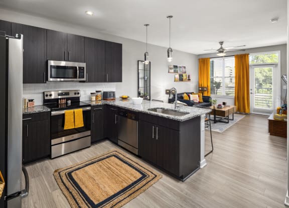 kitchen and living room at the district flats apartments in lenexa, ks  at Abberly Noda Vista Apartment Homes, Charlotte