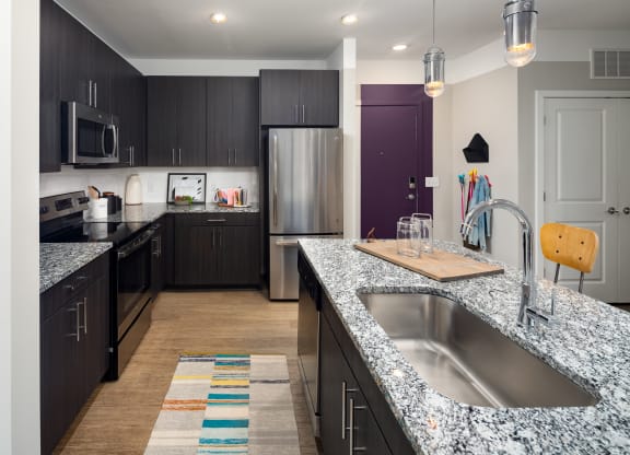 kitchen with granite countertops at the enclave at woodbridge apartments in sugar land, tx  at Abberly Noda Vista Apartment Homes, Charlotte, North Carolina