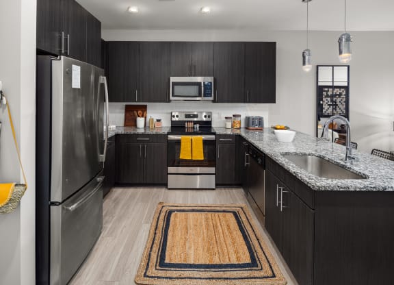 our apartments offer a modern kitchen with stainless steel appliances and granite countertops at Abberly Noda Vista Apartment Homes, Charlotte, NC, 28206