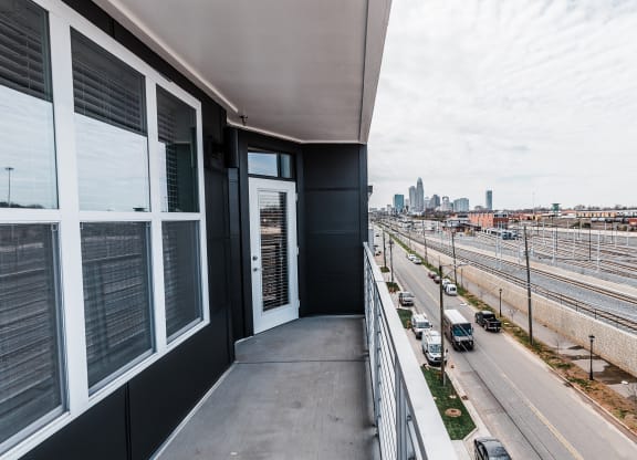 a balcony with a view of the city  at Abberly Noda Vista Apartment Homes, Charlotte, NC, 28206