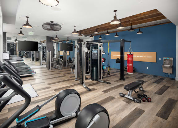 a large fitness room with cardio machines and other exercise equipment  at Abberly Noda Vista Apartment Homes, North Carolina, 28206