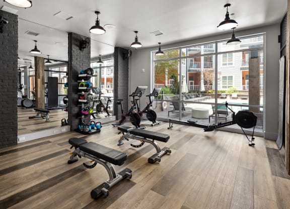 a workout room with weights and other exercise equipment at the casey, 2100 delgany  at Abberly Noda Vista Apartment Homes, Charlotte