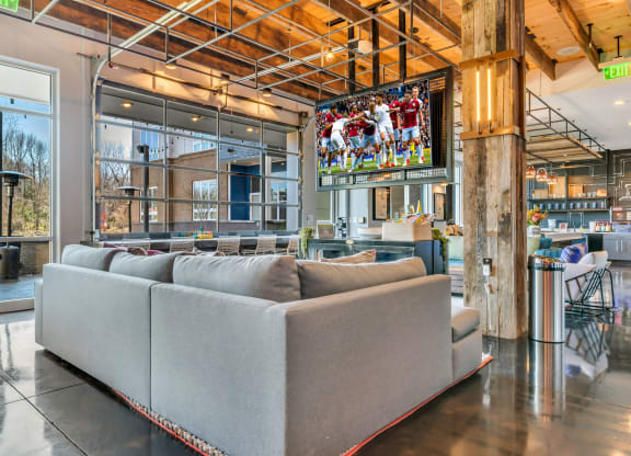 a living room filled with furniture and a flat screen tv  at Abberly Noda Vista Apartment Homes, Charlotte, North Carolina