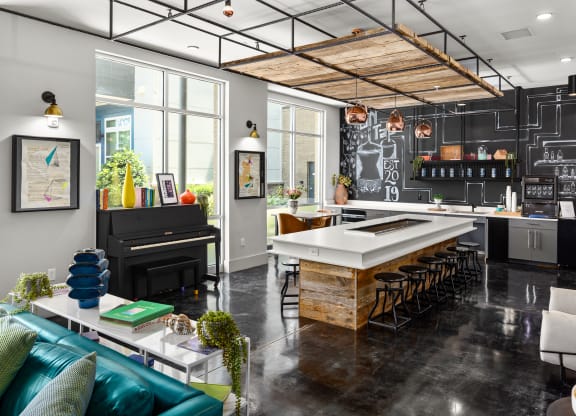 a kitchen with a large island and a piano at Abberly Noda Vista Apartment Homes, North Carolina