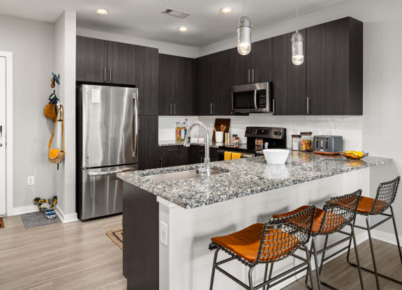 kitchen with granite countertops at the enclave at woodbridge apartments in sugar land, tx  at Abberly Noda Vista Apartment Homes, North Carolina, 28206