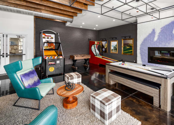 a games room with a foosball table and arcade games at Abberly Noda Vista Apartment Homes, Charlotte, NC
